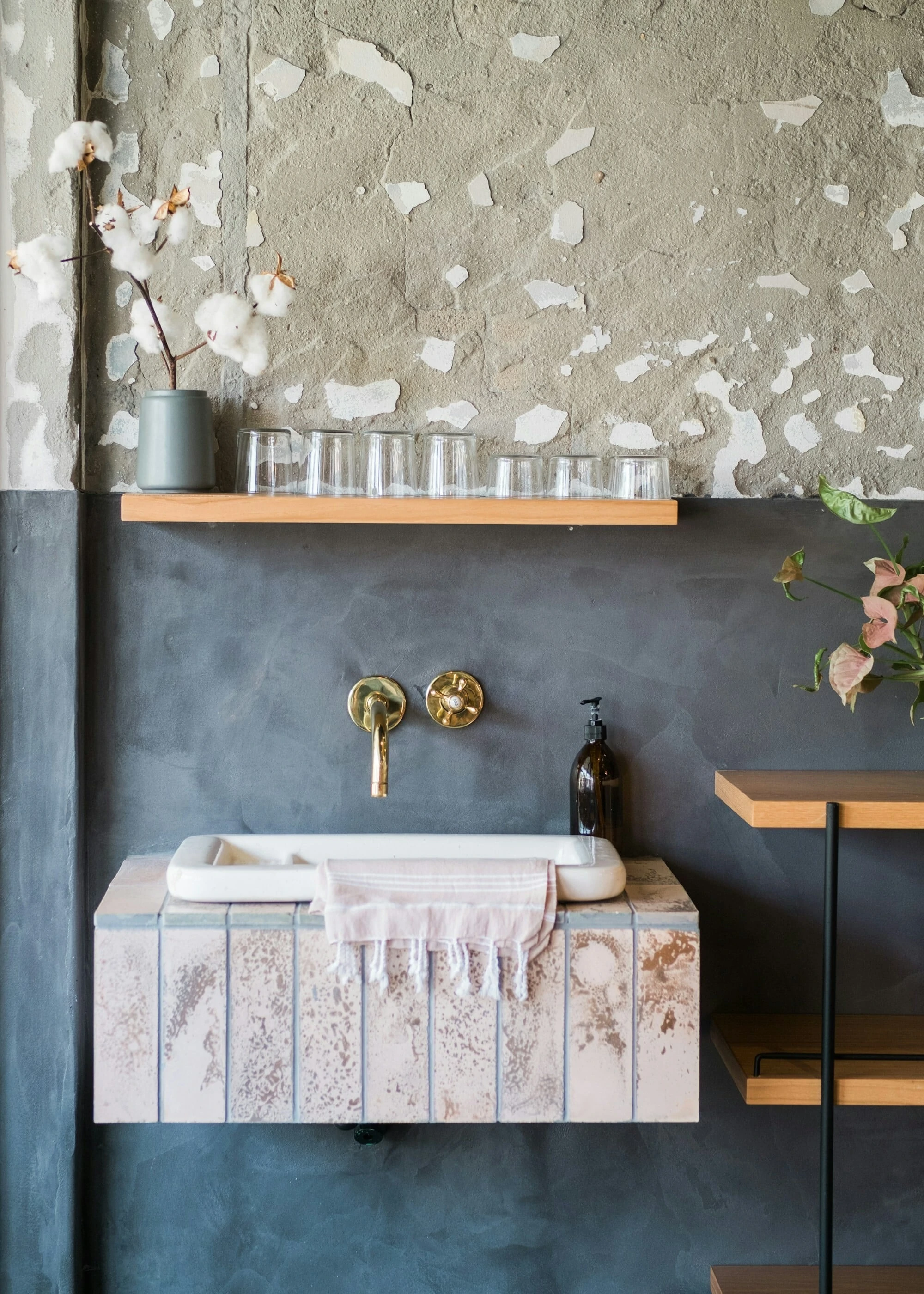Modern bathroom, navy blue 'rocky' textured walls, gold taps
