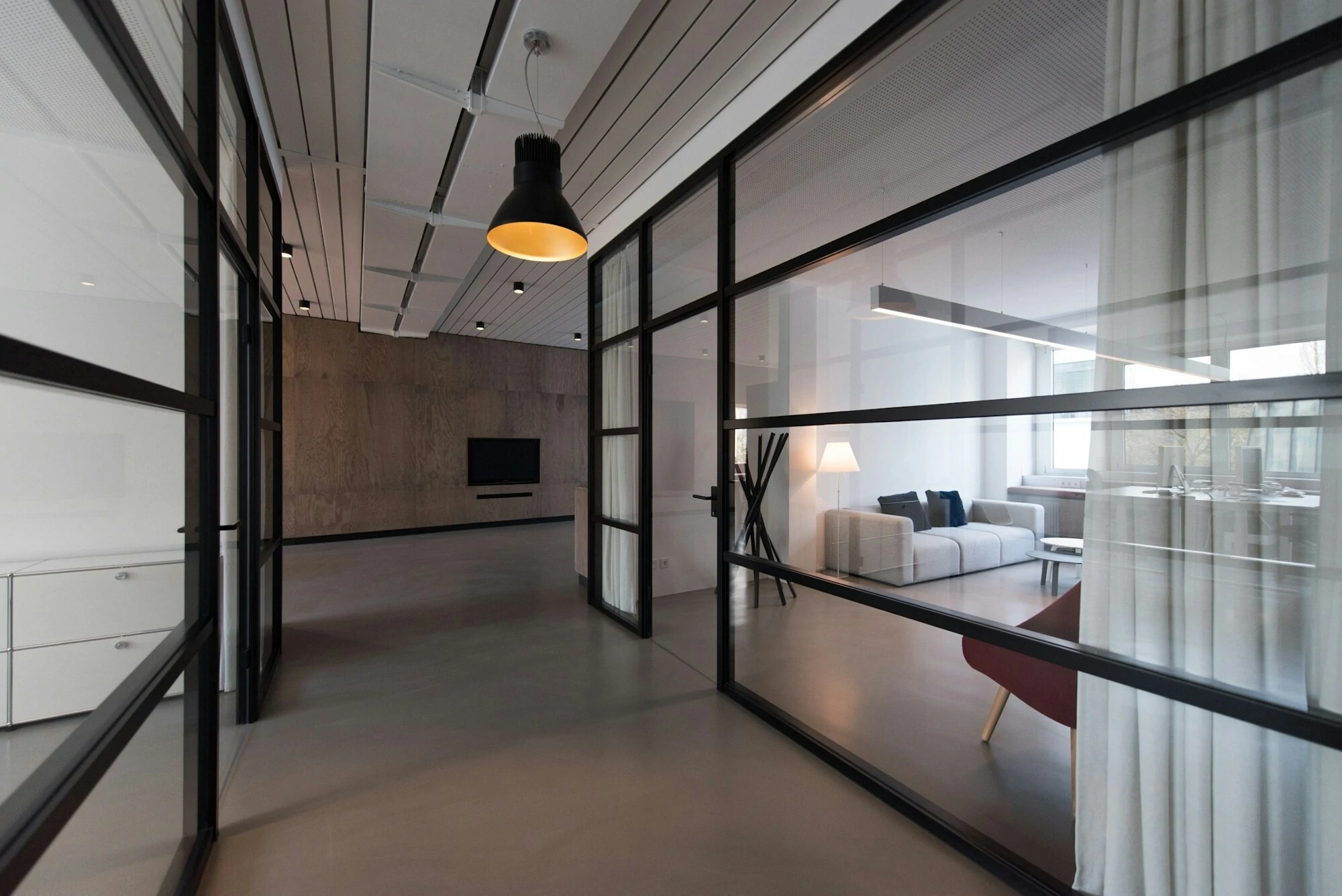 Modern offices with black frames and big windows.