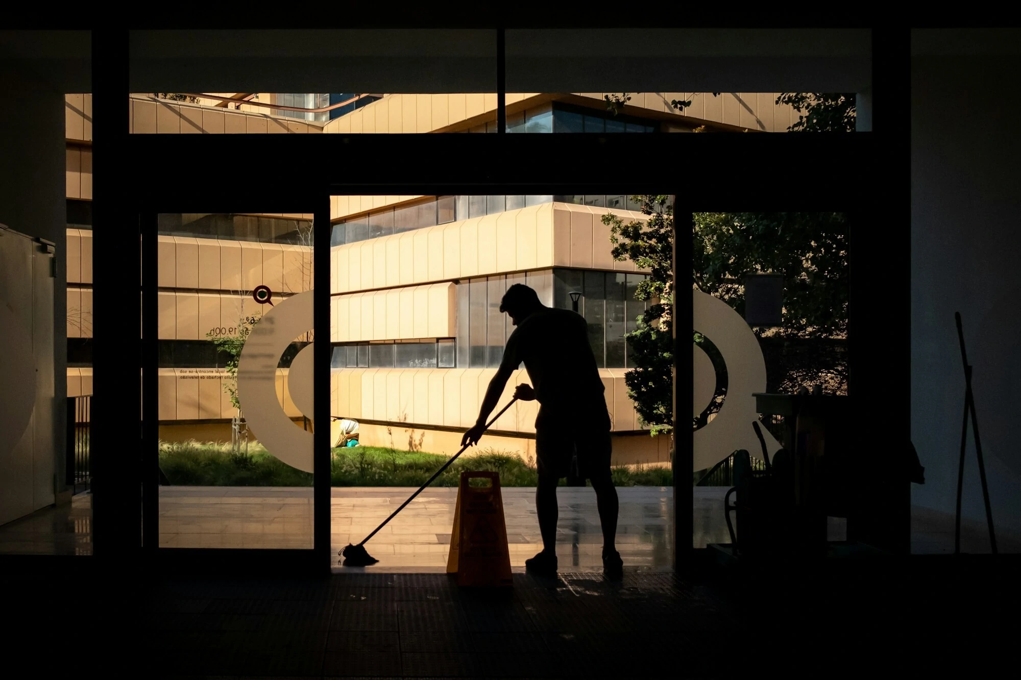 Man mopping the floor in the  dark