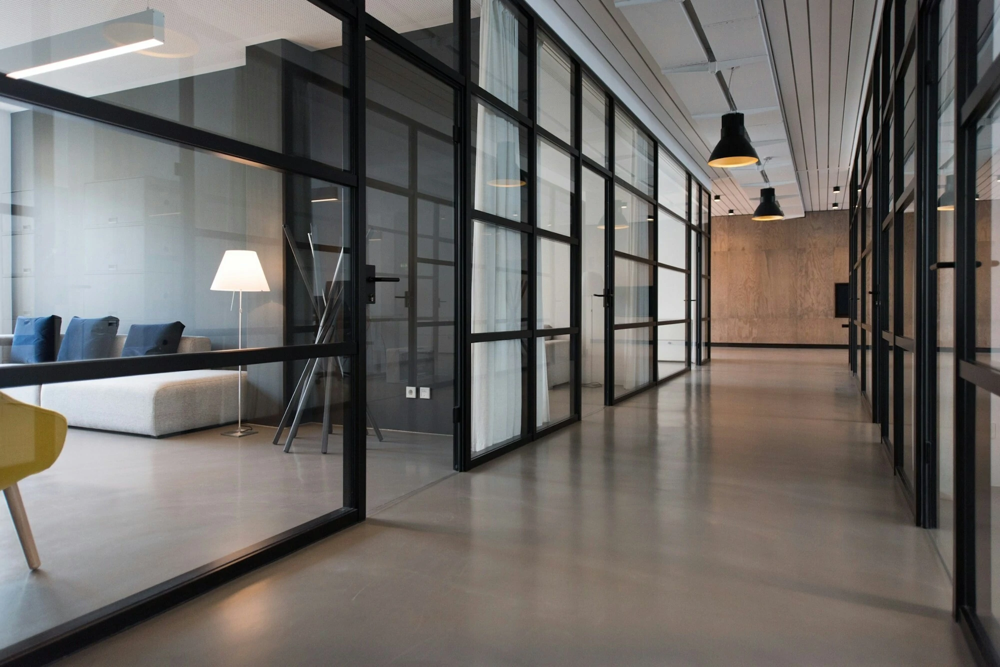 modern open office space with big glass walls and black frames