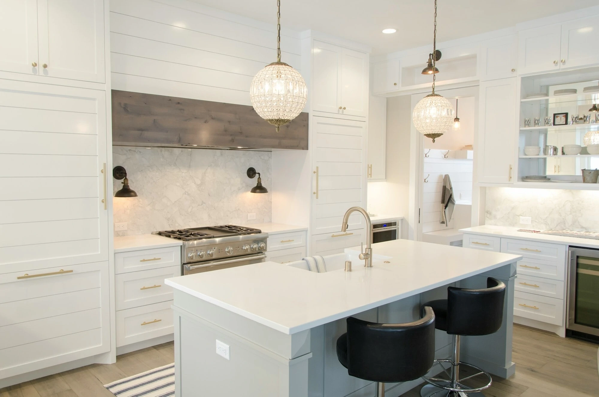 fancy modern kitchen, all white with golden taps and handles.
